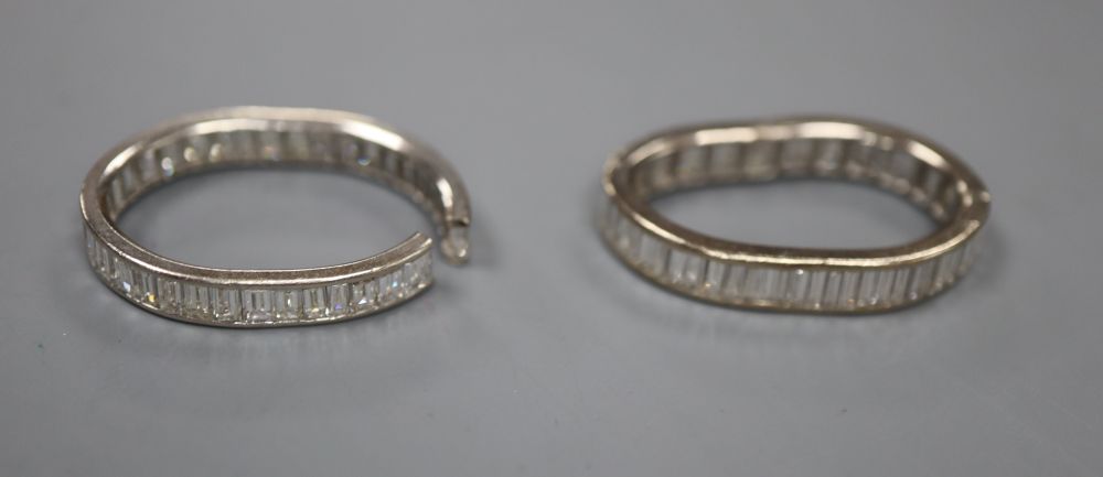 Two white metal and baguette cut diamond set full eternity rings, both very mis-shapen and one shank has been cut, gross 7.8 grams.